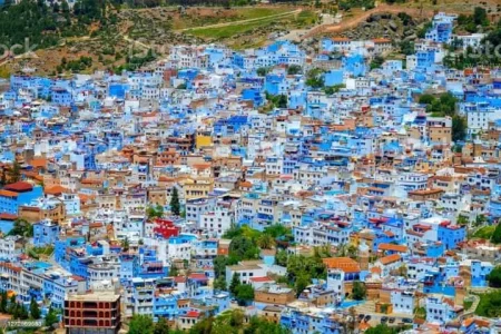 Group of travelers exploring the charming white-washed streets of Tangier on a 10 day Tour tangier excursions, enjoying the rich culture and vibrant colors of Morocco.