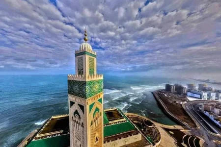 10 days tour from casablanca Spectacular view of the Hassan II Mosque in Casablanca, with its towering minaret overlooking the Atlantic Ocean under a clear blue sky